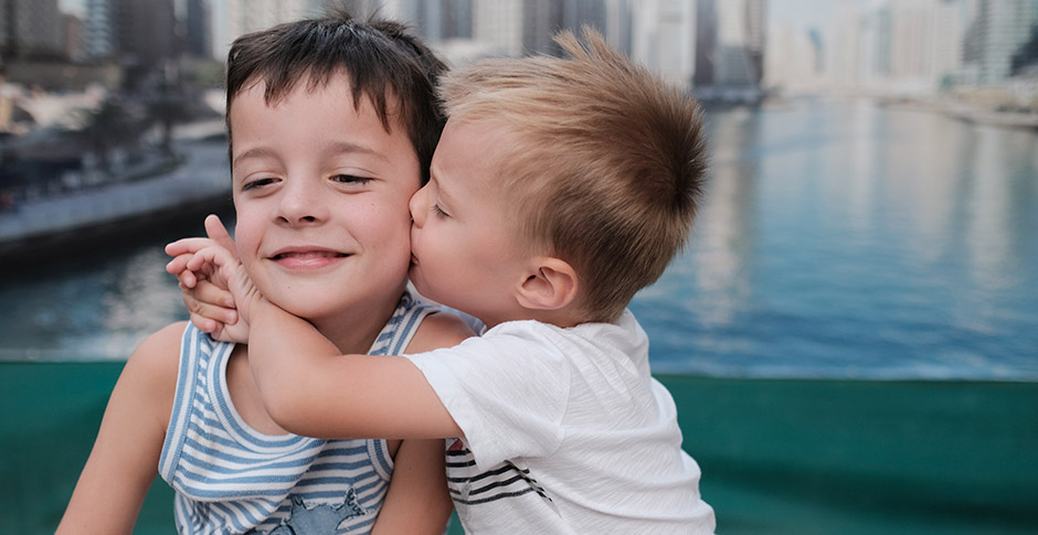 Two boys hugging each other